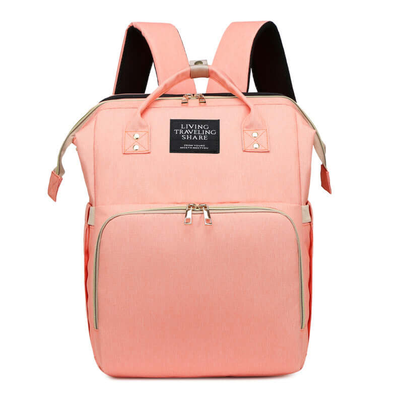 Stylish baby changing backpack in pastel pink color, designed for easy storage and travel with detachable crib.