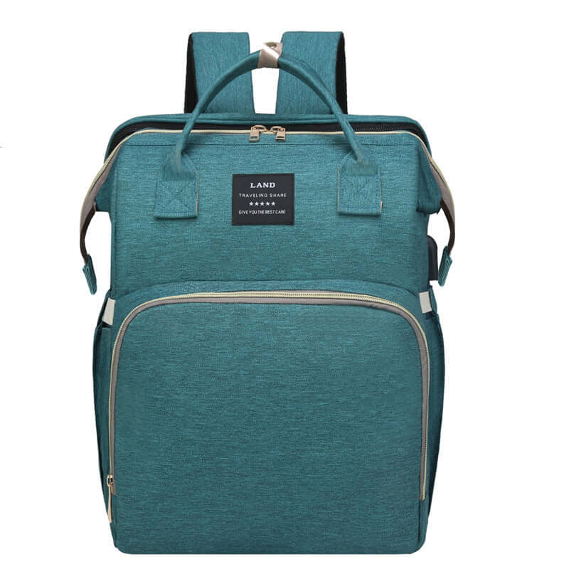 Stylish baby changing backpack in teal color with multiple compartments for easy storage and organization.