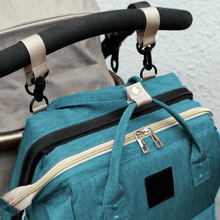 Baby changing backpack with portable crib attached to stroller
