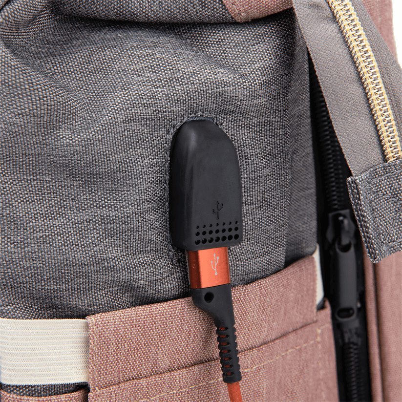 Baby changing backpack with portable crib featuring built-in USB charging port